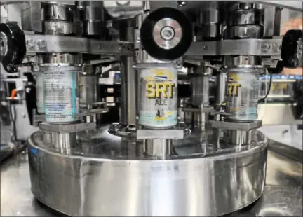  ?? DIGITAL FIRST MEDIA FILE PHOTO ?? This file photo shows cans of SRT Ale being filled at Sly Fox Brewery. Originally launched in 2015, the seasonal ale makes its 2017 debut Saturday. Sales of the ale benefit the Schuylkill River Trail.