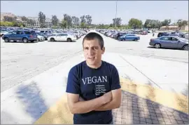  ?? Glenn Koenig
Los Angeles Times ?? NICOLAS TOMAS, a vegan Cal Poly Pomona nutrition major, was told by school administra­tors that he’d have to hand out leaf lets in a free speech zone.