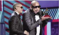  ??  ?? Randy Malcom Martinez (left) and Alexander Delgado, of Gente de Zona, accept the award for Best Tropical Fusion Albu.