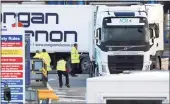  ?? Associated Press ?? Customs officials check vehicles at the P&O ferry terminal in the port at Larne on the north coast of Northern Ireland on Friday.