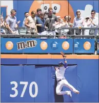  ?? Julio Cortez / Associated Press ?? Spectators look on as New York Mets center fielder Juan Lagares, bottom, goes up to catch a ball hit by San Francisco Giants’ Steven Duggar during the second inning on Thursday in New York.