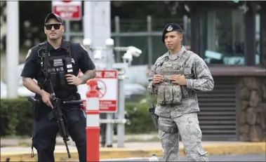  ?? CALEB JONES—ASSOCIATED PRESS ?? Security stands guard outside the main gate at Joint Base Pearl Harbor-Hickam, in Hawaii, Wednesday, Dec. 4, 2019. A shooting at Pearl Harbor Naval Shipyard in Hawaii left at least one person injured Wednesday, military and hospital officials said. Joint Base Pearl Harbor-Hickam spokesman Charles Anthony confirmed that there was an active shooting at Pearl Harbor Naval Shipyard.