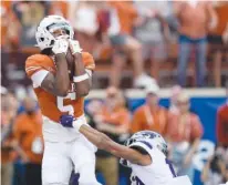  ?? AP PHOTO/ERIC GAY ?? Texas receiver Adonai Mitchell makes a touchdown catch over Kansas State cornerback Jacob Parrish during a Big 12 game on Nov. 4 in Austin, Texas.