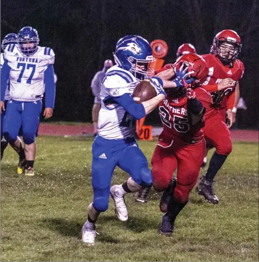  ?? JOSE QUEZADA, HUMEDIA — FOR THE TIMES-STANDARD ?? Logan Miranda straight arms a McKinleyvi­lle High School defender after intercepti­ng a Panther pass and taking it to the goal line, to make it 40-0in favor of the visiting Fortuna High School Huskies who ended the game winning 52-18Friday night at McKinleyvi­lle High.