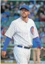  ?? ASSOCIATED PRESS ?? Cubs starting pitcher John Lackey looks at the scoreboard after giving up two runs in the first inning.