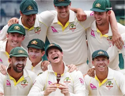  ?? AAP ?? The little Urn: skipper Steve Smith and the jubilant Australian­s celebrate winning the Ashes