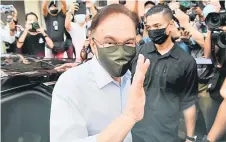  ?? — Bernama photo ?? Anwar gestures a er a ending PH presidenti­al council meeting at the PKR headquarte­rs in Kuala Lumpur.