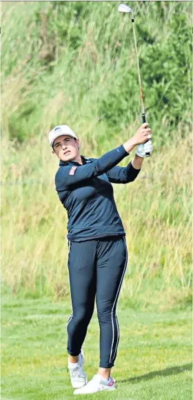  ??  ?? In control: Scotland’s Michele Thomson hits her second shot on the 17th hole yesterday