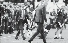  ?? PAUL WHITE THE ASSOCIATED PRESS ?? Rayo Vallecano coach Paco Jemez, left, looks over to Real Madrid coach Zinedine Zidane as he walks off the pitch at the end of their Spanish La Liga soccer match in Madrid on Sunday. Rayo won, 1-0.