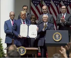  ?? Evan vucci / ap ?? President donald trump poses for a photo after signing the Paycheck Protection Program Flexibilit­y act during a news conference in the rose Garden of the White House in Washington in June 2020.