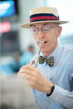  ??  ?? Leighton, 68, is retiring after 25 years with the Metropolit­an Washington Airports Authority, but he’ll continue to serve as musician-at-large at the airport. —WP-Bloomberg photos