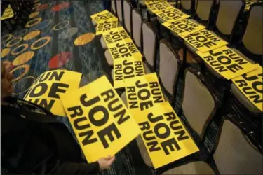  ?? ANDREW HARNIK — THE ASSOCIATED PRESS ?? Workers lay out signs that read “Run Joe Run” ahead of a speech by former Vice President Joe Biden to the Internatio­nal Associatio­n of Firefighte­rs at the Hyatt Regency on Capitol Hill in Washington, Tuesday, March 12.