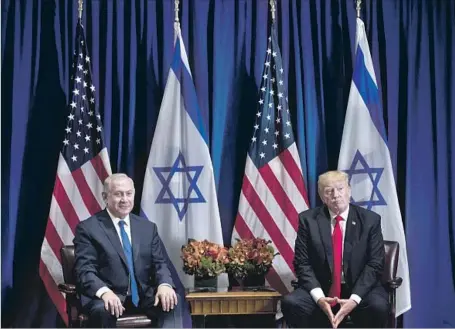  ?? Brendan Smialowski AFP/Getty Images ?? ISRAELI PRIME MINISTER Benjamin Netanyahu, left, appeared pleased by President Trump’s derision of the nuclear deal with Iran.