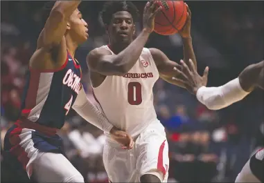  ?? NWA Democrat-Gazette/J.T. Wampler ?? COMING BACK: Arkansas’ Jaylen Barford looks for help against Ole Miss defender Breein Tyree during a March 10 game in the Southeaste­rn Conference tournament in Nashville, Tenn. Barford announced Tuesday that he is returning to Arkansas for his senior...