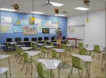  ?? CONTRIBUTE­D PHOTOS ?? Dayton Regional STEM School social studies teacher Nick Pant prepares in his classroom for the new school year.