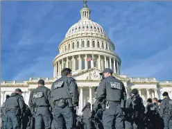  ?? ?? A large group of police arrive at the Capitol, on Thursday, in Washington D.C.
