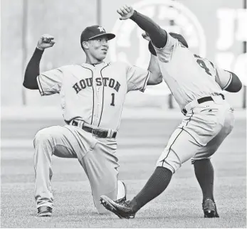  ?? MATT MARTON, USA TODAY SPORTS ?? Top prospect Carlos Correa, left, warms up Monday before making his major league debut.