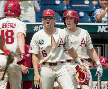  ?? NWA Democrat-Gazette/BEN GOFF ?? Hunter Wilson (6) and Carson Shaddy (right) celebrate after Luke Bonfield’s home run brought Heston Kjerstad (18) in to score in the fifth inning of Sunday’s 11-5 victory over Texas in the College World Series at TD Ameritrade Park in Omaha, Neb. Kjerstad went 3 for 5 with 3 RBI and 2 runs scored as the Razorbacks pounded out 15 hits.