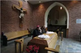  ?? CARLOS OSORIO—FILE — THE ASSOCIATED PRESS ?? In this file photo, Archbishop Allen Vigneron, left, and Michael Sullivan, Provincial Minister of the Capuchin Franciscan Province of St. Joseph, pray at the tomb of Father Solanus Casey in Detroit. The Detroit priest, who is credited with helping cure...