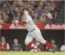  ?? AP PHOTO ?? IT'S GONNA FALL: Red Sox utility player Brock Holt watches his RBI single in the second inning of Tuesday night's 10-1 blowout win over the Angels in Anaheim, Calif.
