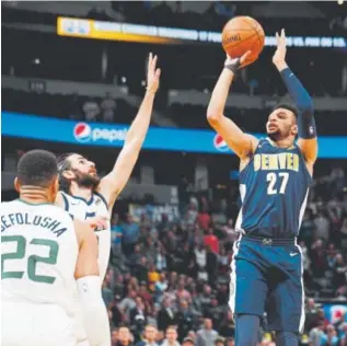  ?? David Zalubowski, The Associated Press ?? Nuggets guard Jamal Murray tries to score against the Jazz in Denver on Friday night.