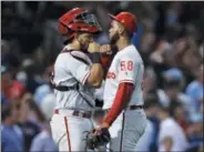  ?? CHARLES KRUPA— THE ASSOCIATED PRESS ?? Phillies relief pitcher Seranthony Dominguez, right, is congratula­ted by catcher Jorge Alfaro after earning the save after a 3- 1win over the host Boston Red Sox Tuesday night in Fenway Park.