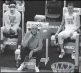  ?? Associated Press ?? WATCH IT FALL Syracuse head coach Jim Boeheim, seated front, watches a shot as his son guard Buddy Boeheim (35) looks in the second round of the ACC tournament in Greensboro, N.C., Wednesday.