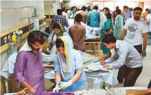  ?? AFP ?? Heatstroke victims being treated at a hospital in Karachi. The federal government has issued a notificati­on to declare fourmajor hospitals as federal health entities.