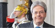  ?? FOTO: AFP ?? Der neue italienisc­he Ministerpr­äsident Paolo Gentiloni (re.) gilt als ein erfahrener und ausgewogen­er Politiker.