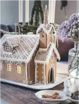  ??  ?? sitting ROOM Helped by the children, Julie created the intricate gingerbrea­d house, as well as cookies, meringues and homemade chocolate truffles. ‘I do all the baking with my kids,’ says Julie. try the biscuiteer­s DIY gingerbrea­d house kit, £34.99, Selfridges