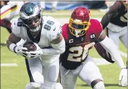  ?? DANIEL KUCIN JR. - AP ?? Philadelph­ia Eagles tight end Zach Ertz (86) slips past Washington Football Team safety Landon Collins (20) during a match the against the Washington Football Team in an NFL game, Sunday, in Landover, Md.