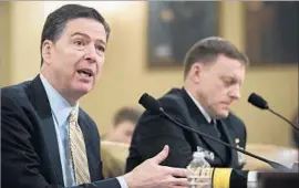  ?? Drew Angerer Getty Images ?? FBI CHIEF James B. Comey, left, and NSA head Michael S. Rogers discussed few details of the Russia inquiry, giving Democrats room to posit a possible narrative.