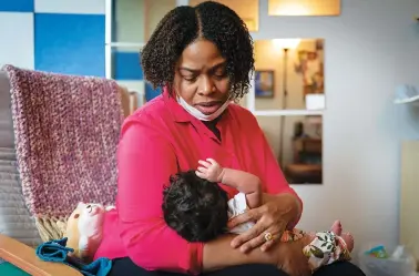  ?? AP PHOTO/JACQUELYN MARTIN ?? Capri Isidoro, of Ellicott City, Md., looks at her one-month-old baby Charlotte on Monday in Columbia, Md., during a lactation consultati­on.