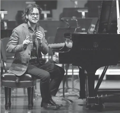  ?? DAN JANISSE ?? Concert pianist Daniel Wnukowski talks to students from Immaculate Conception Elementary School Friday at the Capitol Theatre.