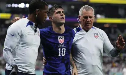  ?? ?? Christian Pulisic is helped off the pitch after suffering a pelvic injury against Iran on Tuesday. Photograph: Manu Fernández/AP