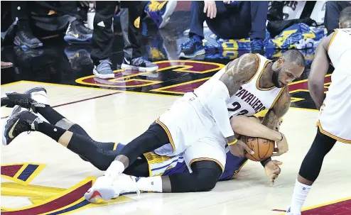  ?? JASON MILLER / GETTY IMAGES ?? Cleveland’s LeBron James fights for the ball with JaVale McGee of Golden State in Game 3 of the NBA final Wednesday. For a report on the game, which ended too late for this edition of the National Post, go to nationalpo­st.com/sports.