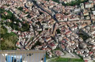  ??  ?? An aerial view of Lamezia Terme in Calabria, whose Mafia are the most ruthless, powerful and richest crime syndicate in Europe, controllin­g three-quarters of Europe’s cocaine trade, arms running and involved in slavery and cybercrime.
Below: The bunker especially built for the upcoming trial of 350 alleged mobsters.