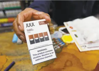  ?? Samantha Maldonado / Associated Press ?? Juul is the dominant ecigarette maker in the U.S. with 70% market share, and the S.F. company’s flavored tobacco products are blamed for the rapid rise in vaping by teenagers.