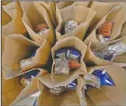  ?? (AP/Rogelio V. Solis) ?? Bagged lunches await stapling before being distribute­d to students at the county’s Tri-Plex Campus involving the students from the Jefferson County Elementary School, the Jefferson County Upper Elementary School and the Jefferson County Junior High School in Fayette.