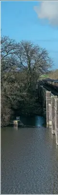  ?? RALPH WARD ?? ‘MICKEY MOUSE’ AWAKENS: Shortly after sunrise on January 12 at 08.15, BR Ivatt ‘2MT’ 2-6-0 No. 46521 approaches Rabbit Bridge, Swithland, with a train of Mk.1 Suburban carriages during an organised Timeline Events photograph­ic charter.