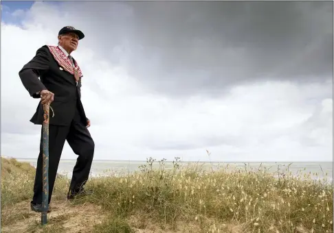  ?? THE ASSOCIATED PRESS ?? World War II D-Day veteran and Penobscot Elder from Maine, Charles Norman Shay poses on the dune overlookin­g Omaha Beach prior to a ceremony at his memorial in Saint-Laurent-sur-Mer, Normandy, France, June 5.