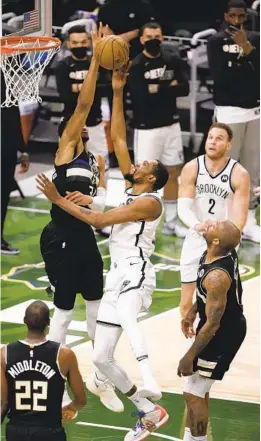  ?? JEFFREY PHELPS AP ?? Bucks forward Giannis Antetokoun­mpo, who had 30 points, goes up to block the shot of Nets forward Kevin Durant, who had 32 points, during the first half.