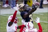  ?? MICHAEL CONROY — THE ASSOCIATED PRESS ?? Purdue wide receiver David Bell makes a catch over Nebraska’s Marquel Dismuke, left, and Cam Taylor-Britt.