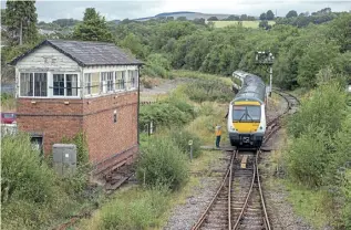  ?? KEN BRUNT ?? The junction at Tondu, north of Bridgend, on August 11, as the driver of No. 170205 exchanges a token with the signalman, the DMU forming the 2G60/12.14 Maesteg to Gloucester.