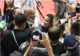  ?? VNS Photo Đoàn Tùng ?? IN THE LIMELIGHT: Martial artist Nguyễn Thị Thu Hà (centre) surrounded after winning gold in the women’s trio performanc­e event.