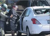  ?? MINDY SCHAUER — THE ORANGE COUNTY REGISTER ?? A woman is taken into custody afterwitne­sses said she drove her car into a crowd of protesters in Yorba Linda on Saturday.