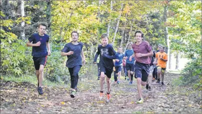  ?? ERIC MCCARTHY/JOURNAL PIONEER ?? Jarvis McRae, right, matches strides with the lead group of runners early in the Zone 1 bantam boys cross-country race Wednesday, at Mill River Experience Park. McRae, running for M.E. Callaghan School, would pick up the pace and win the race by 34...