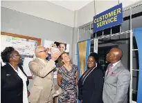  ?? NORMAN GRINDLEY/CHIEF PHOTO EDITOR ?? From left: Director of Public Prosecutio­ns Paula Llewellyn; Justice Minister Delroy Chuck; Canadian High Commission­er Laurie Peters; senior parish court judge, Opal Smith; and Chief Justice Bryan Sykes are about to enter the customer service area at...