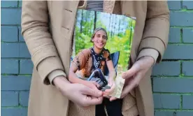  ?? RJ Rico/AP ?? Vienna holds a photo of their slain partner, Tortuguita, in Atlanta in January. Photograph: