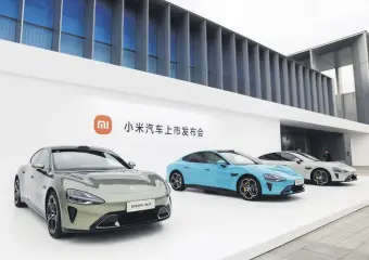  ?? ?? Xiaomi SU7 electric cars displayed at Beijing Etrong Internatio­nal Exhibition and Convention Center, Beijing, China, March 28, 2024.